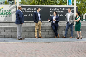 Students standing at Mason Arlington Campus in business attire.