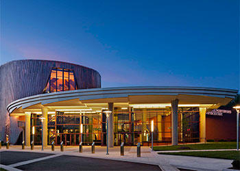 Hylton Performing Arts Center at night with the lights on.