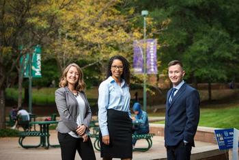 3 Mason students standing on campus in professional attire.
