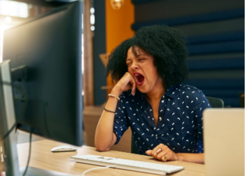 Woman yawning while sitting at her desk in front of her laptop. Photo: PeopleImages/E+/Getty Images. https://elemental.medium.com/all-the-reasons-youre-always-tired-65daccf6436